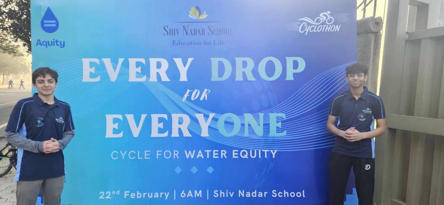 The two founders beside the Every Drop for Everyone cyclothon banner