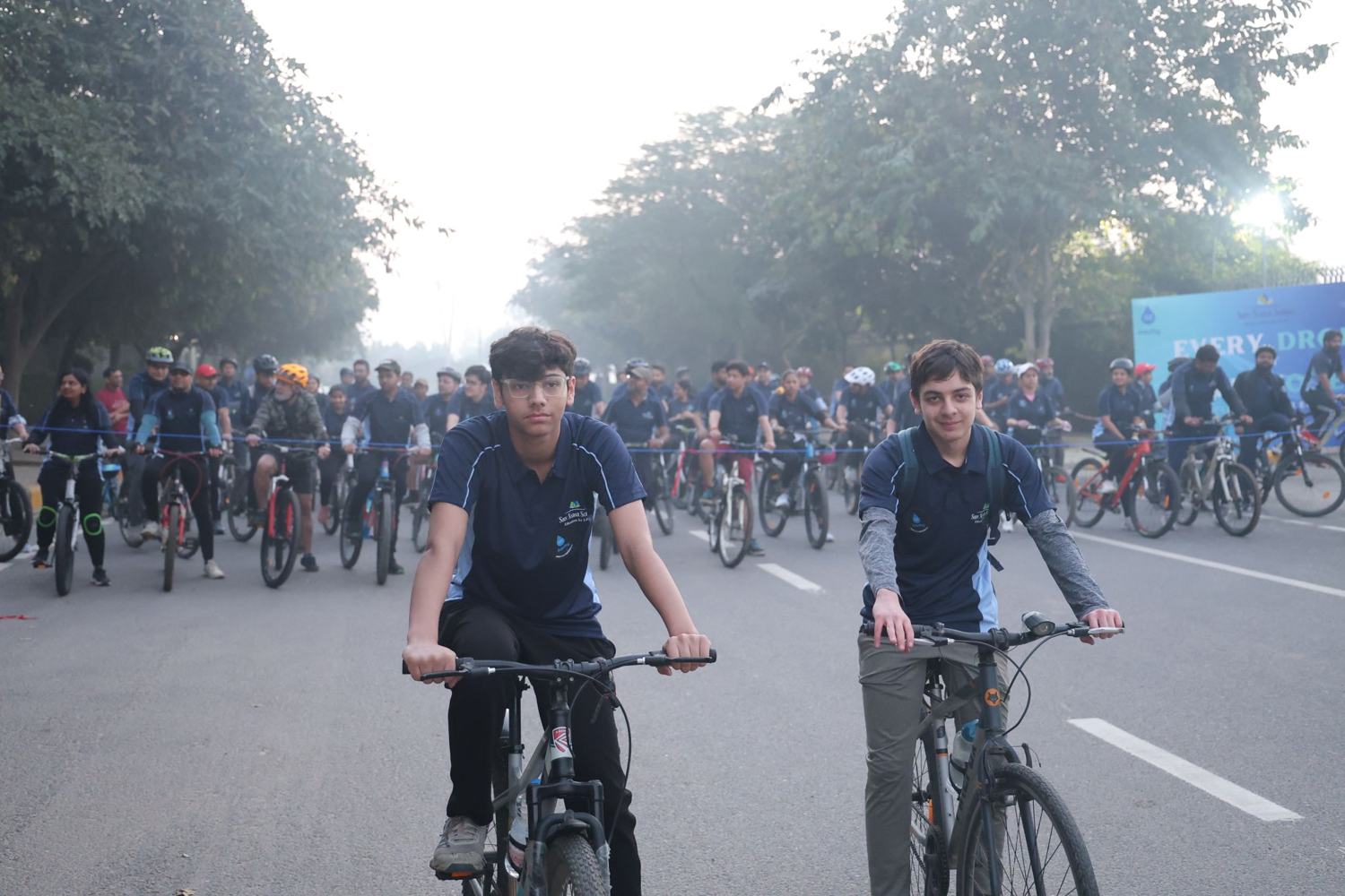 The two founders on bicycles at the front of the crowd of riders